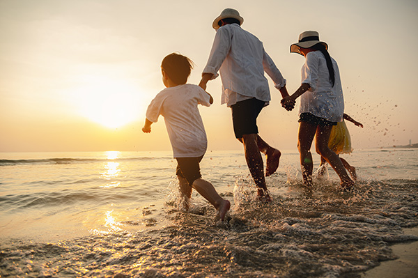 Family running free on the beach